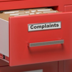 red file drawer with the word complaint