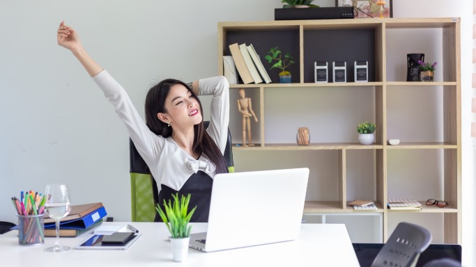 Woman stretching at her desk | VRM Rental Software